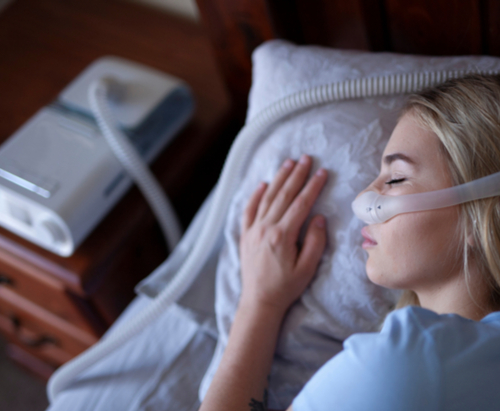 Woman wearing CPAP Machine while sleeping