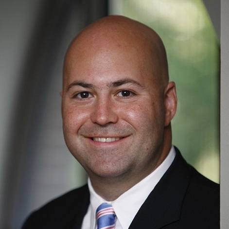 Chris Nace wearing a suit.