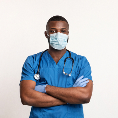 Male black medical professional in scrubs and mask with arms crossed