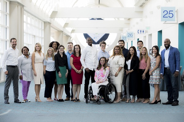 Group of people standing in a long hallway