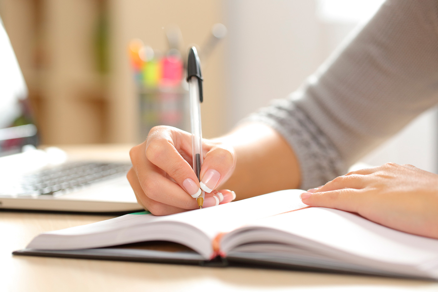 woman writing in book