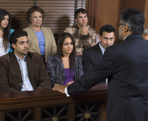 Group of jurors listening to attorney.