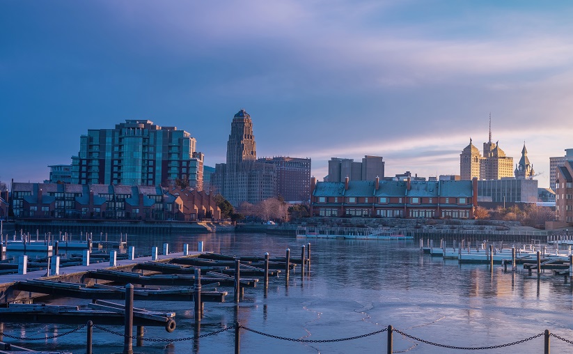 View of Buffalo, New York skyline from the water with docks in the foreground.