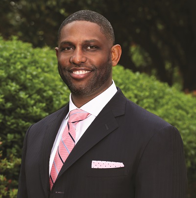 Navan Ward in a dark suit with pink tie