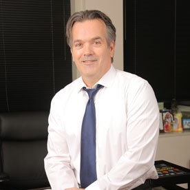 Dan Buba in an office wearing a white shirt and tie