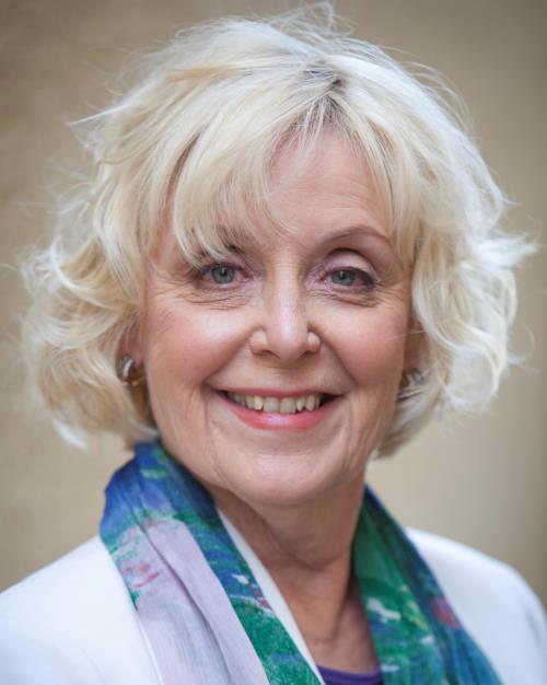 Katherine James wearing a white sweater and scarf