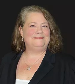 Amy Heins in front a dark background.