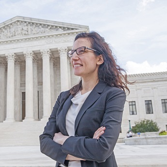 Woman in suit in front of Supreme Court
