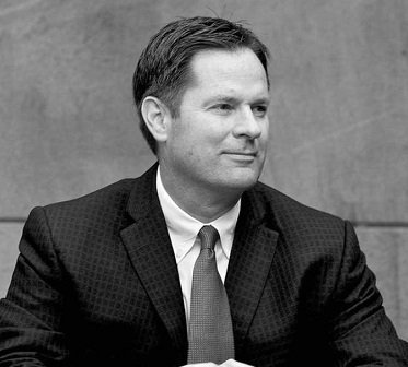 Black and white headshot of a man looking to the left