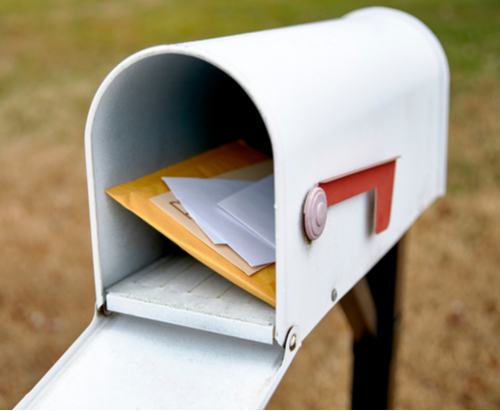 White mailbox with letters inside