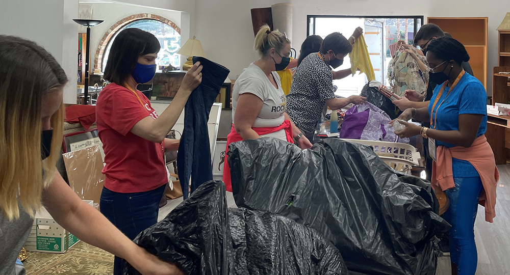 Photo of AAJ members sorting and organizing items at the Elder Love thrift store