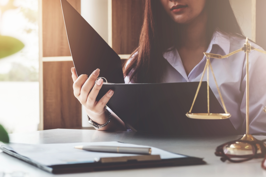 Woman reading binder at desk