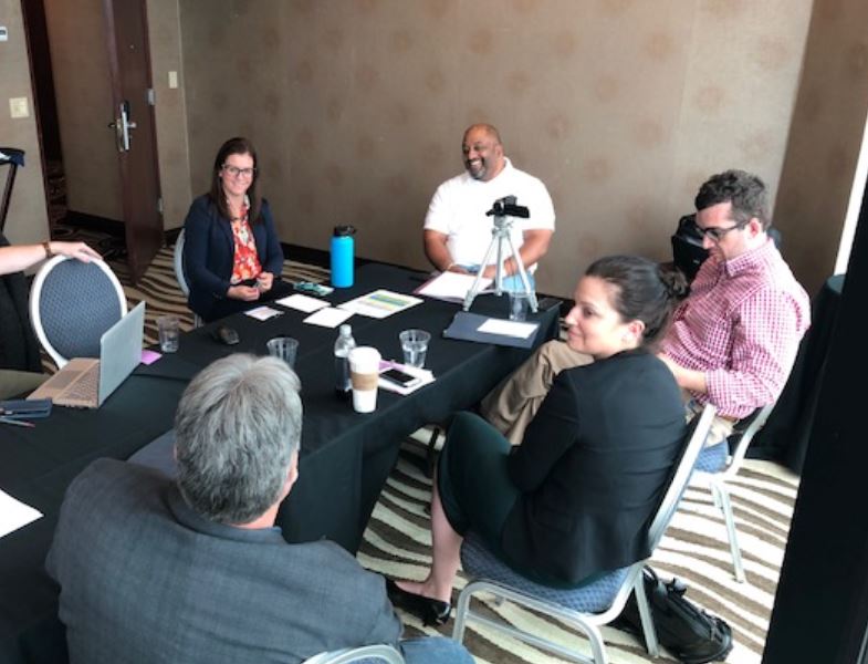 Group in a conference room practicing trial advocacy skills.